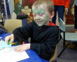 Bailey dressed as a witch enjoys Storytime