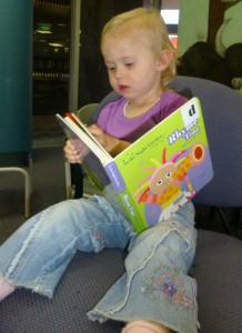 Olivia chooses a book to take home