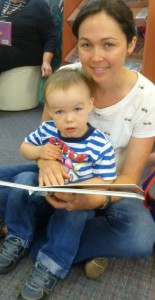 Lucy reads with Hamish age 2, before Storytime starts at 11am