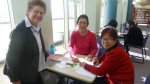 Volunteer Corrine helps Mei with Carmel looking on