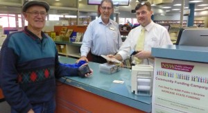 Patron Les, meets Orange City Librarian Sean Brady with Peter Douglass helping out