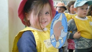 Courtnee, 3, waves a Freeda the Reader flag